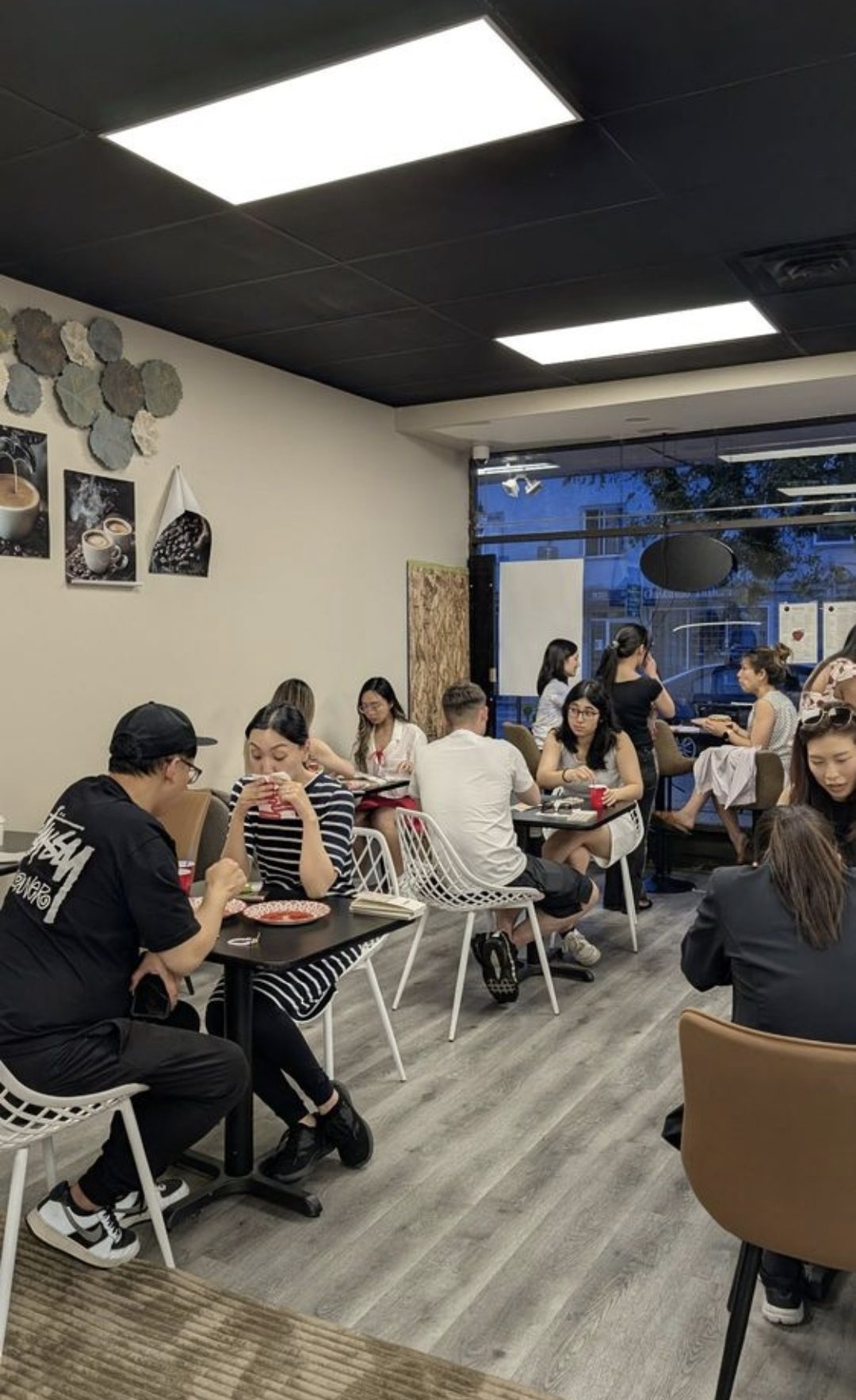 A full room of guests at the tables in You N Me' Café