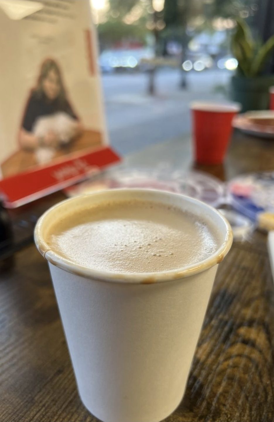 A hot drink on the table by the window looking onto 12th Street