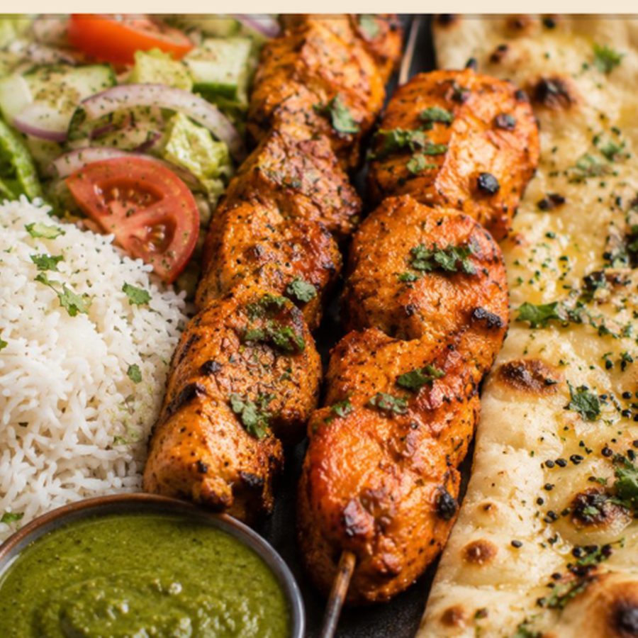Two chicken kebabs with garlic naan and rice