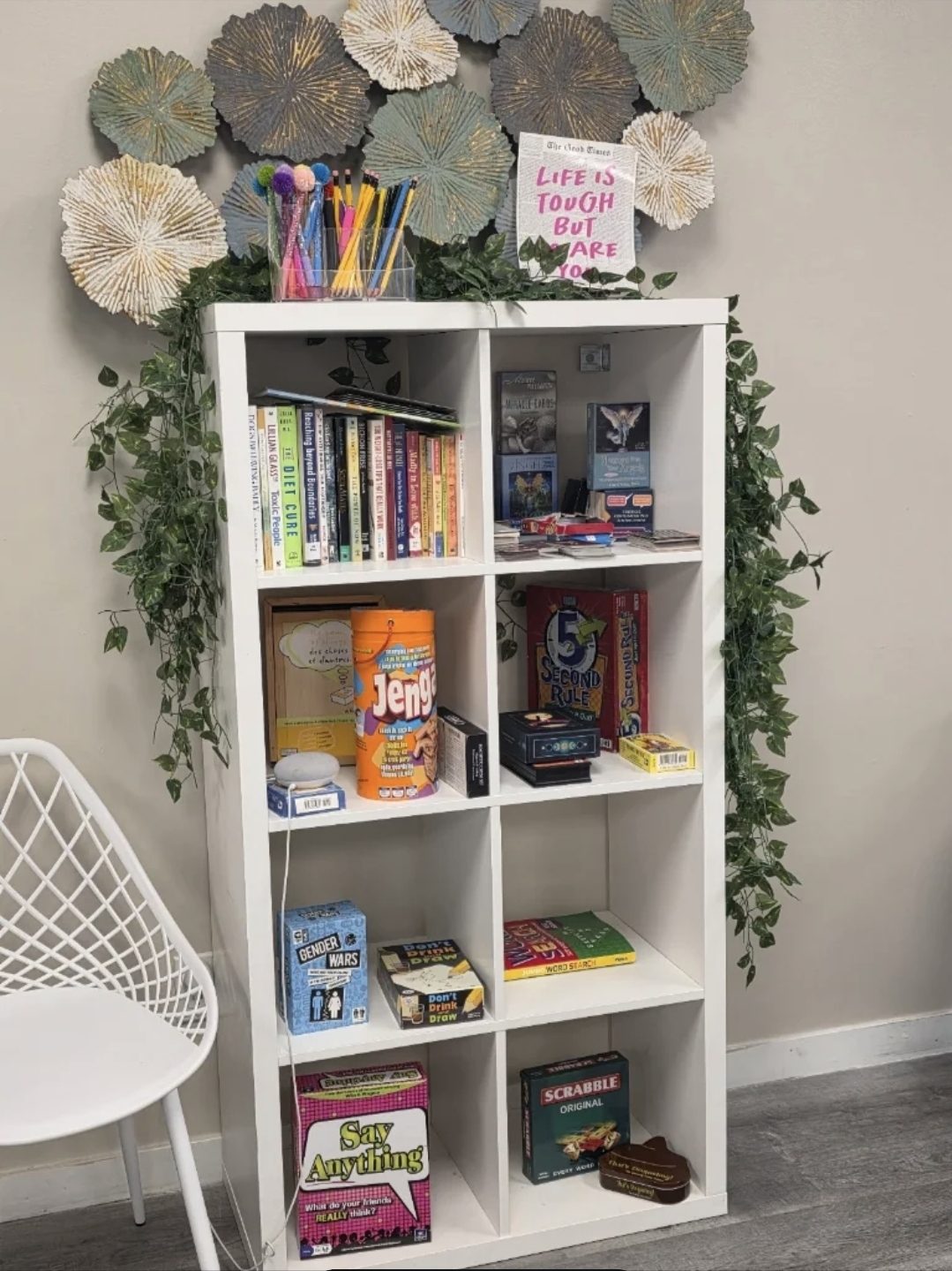 The shelf of board games and books at You N Me' Café