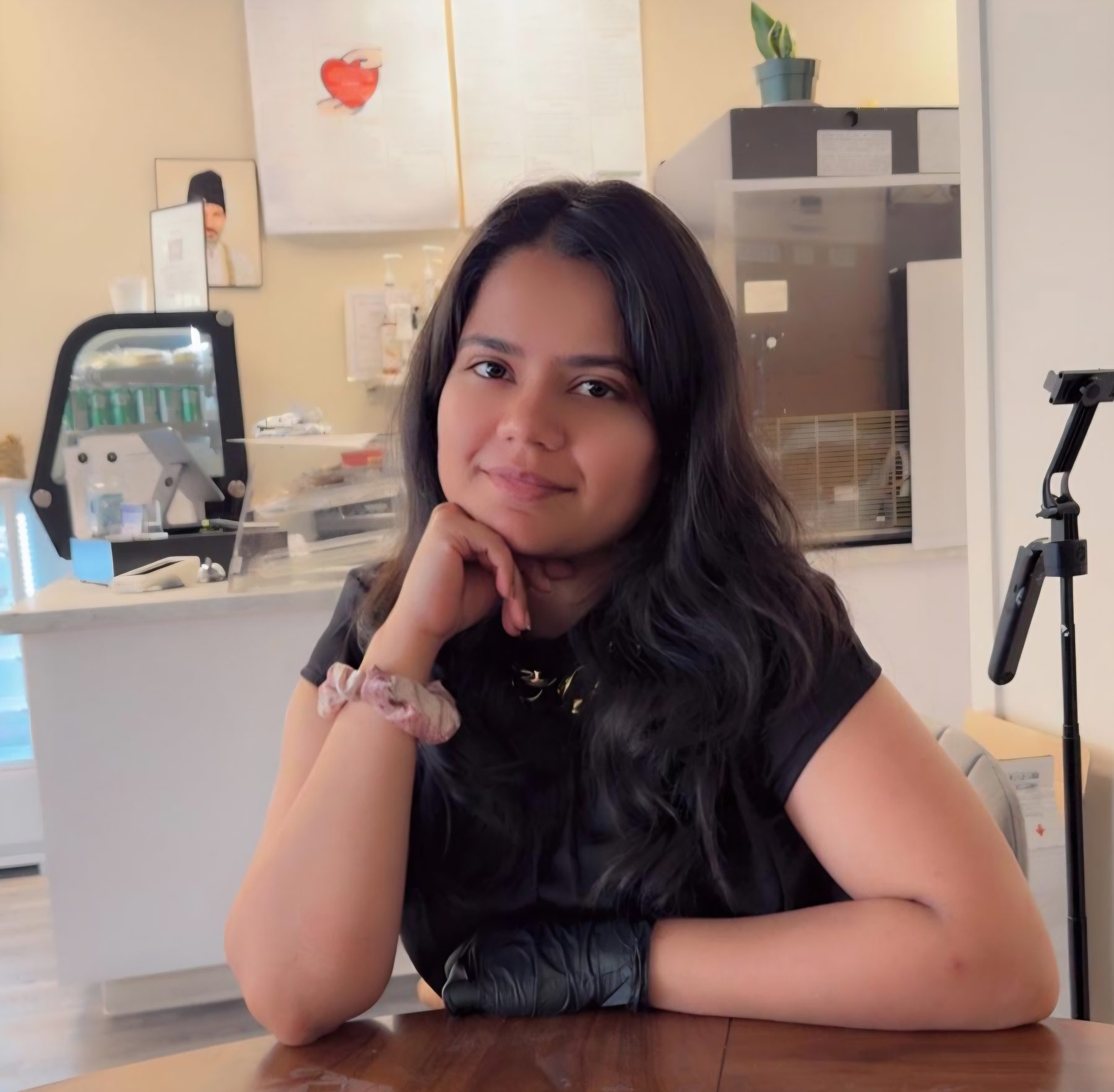 Amrin Satani, founder of You N Me' Café, at a table in the café