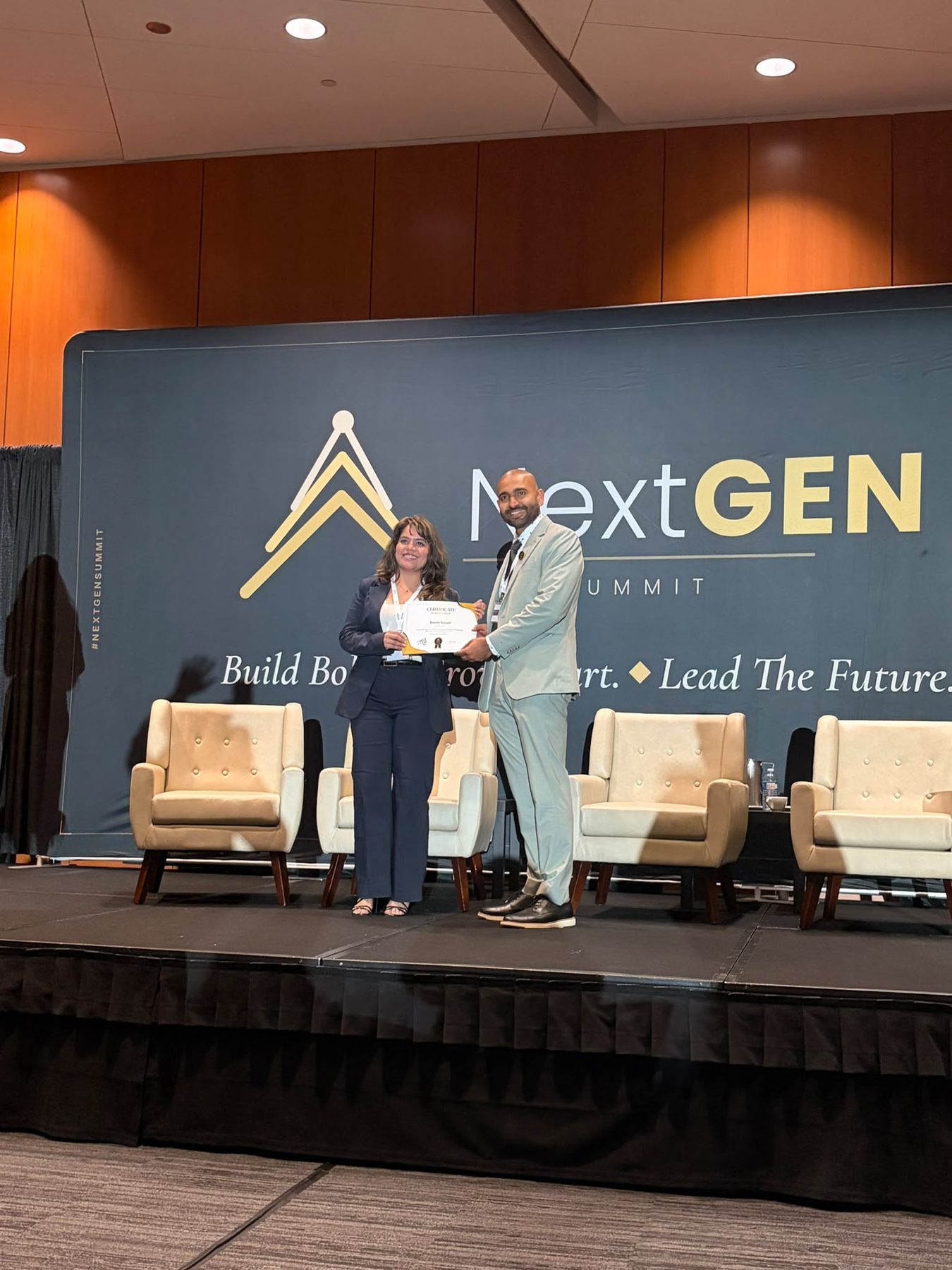 Amrin on stage at the NextGen Summit